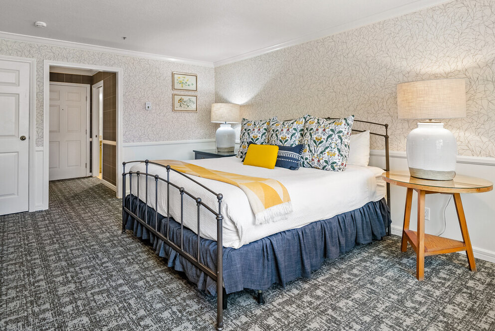 a bed with a lamp and a table