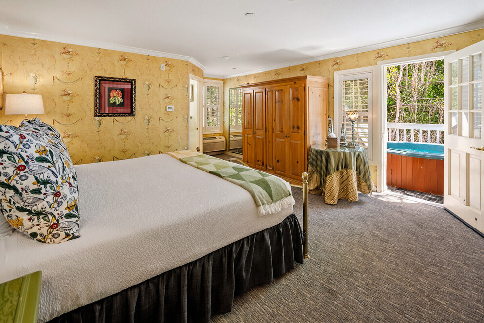 a bedroom with a bed and a bathtub