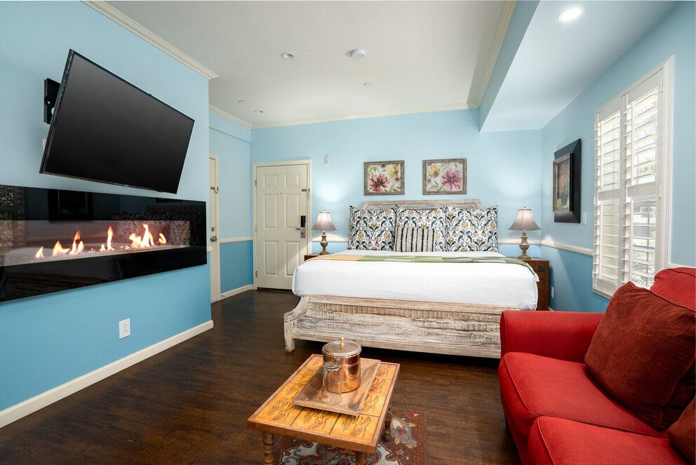 a room with a bed and a fireplace