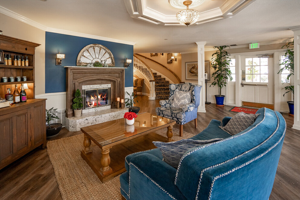 a living room with a fireplace and blue walls